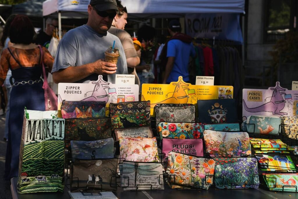 Man at market browsing colorful pouches and bags