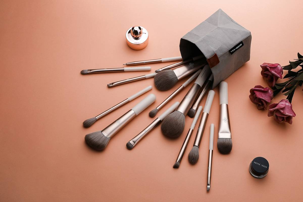 Side-by-side comparison: cluttered Pinterest-inspired makeup kit vs. streamlined real-world essentials kit with 8 core items
